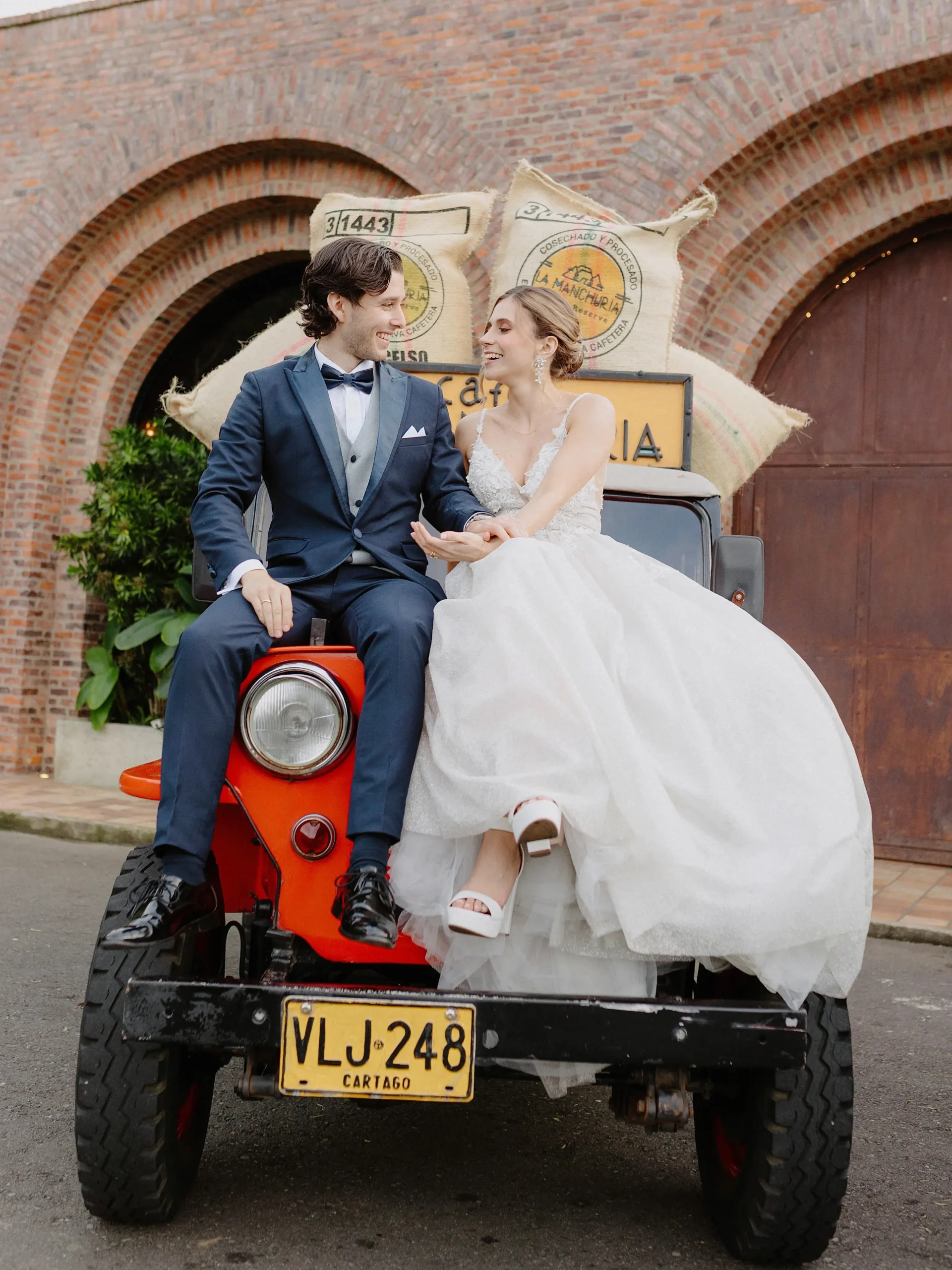 Manuela & Juan José posing with vintage Jeep at Voilá Medellín