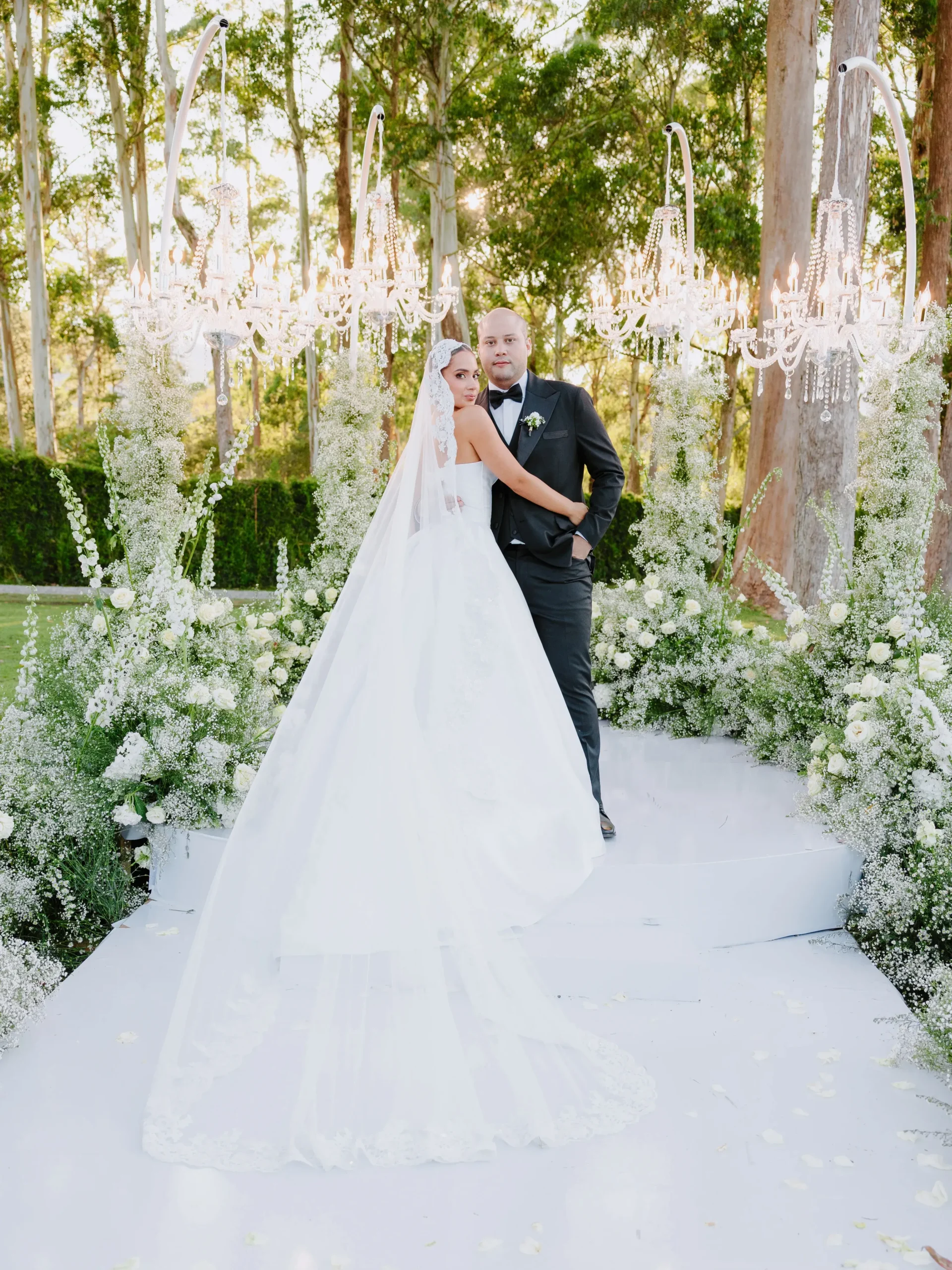 Bride and groom romantic portrait at floral ceremony altar for Llanogrande wedding