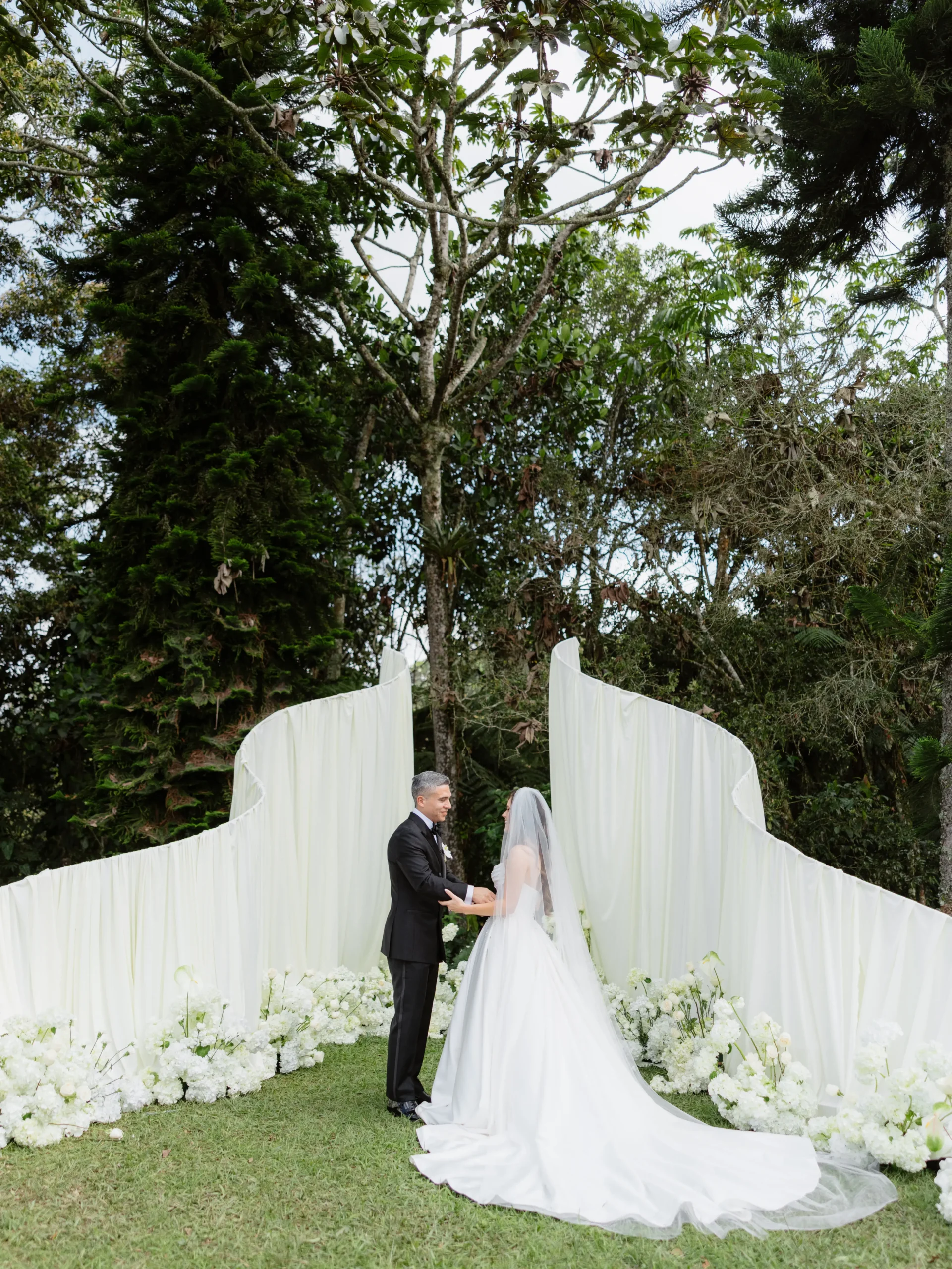Outdoor wedding ceremony aisle with white florals in Medellín